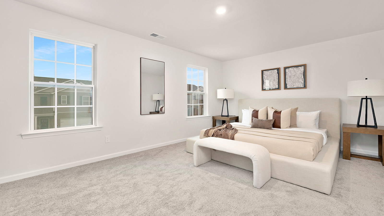 Primary bedroom, carpeted with two large windows