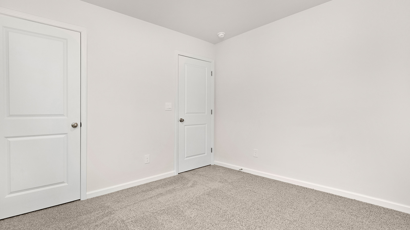 Carpeted bedroom with large window