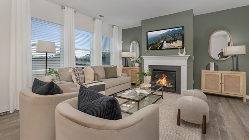 Open concept living area near kitchen and dining area with fireplace and large windows
