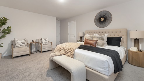 Primary bedroom carpeted with large window