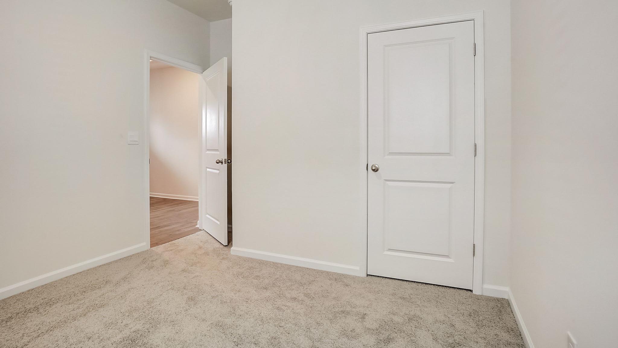 Carpeted bedroom with large window