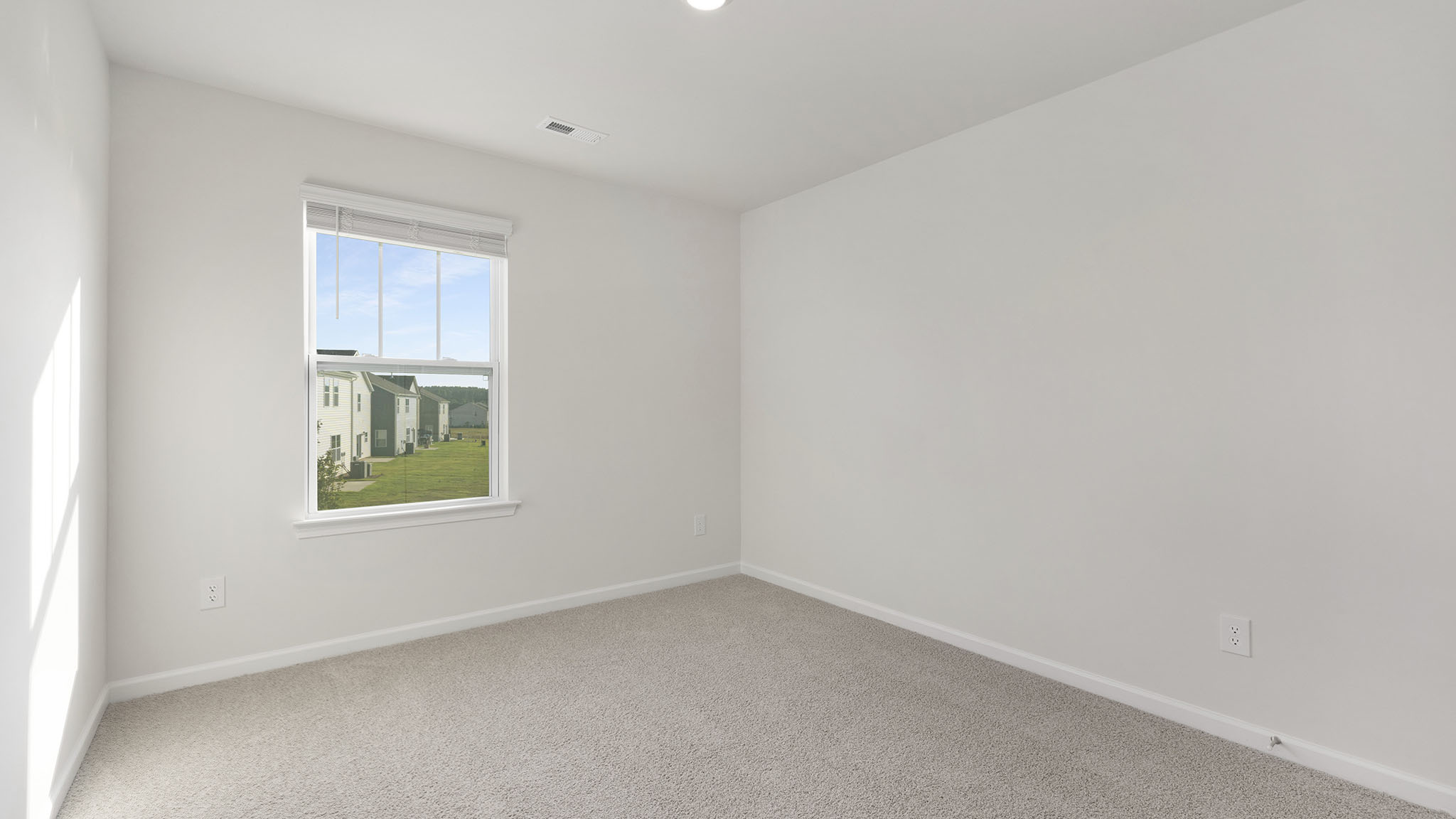 carpeted bedroom with windows