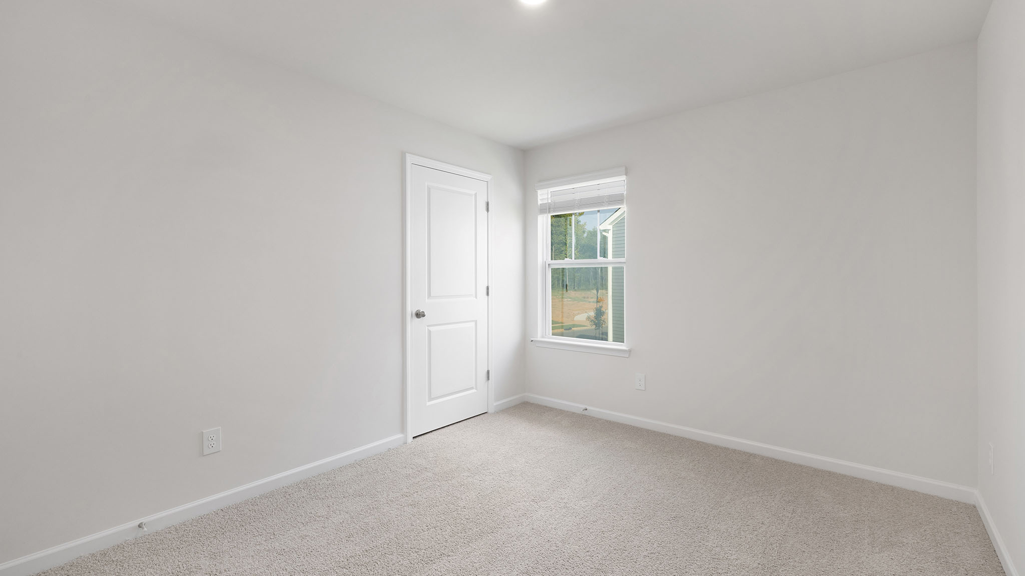 carpeted bedroom with windows