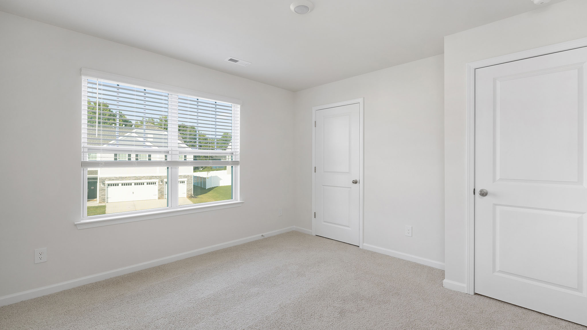 carpeted bedroom with windows