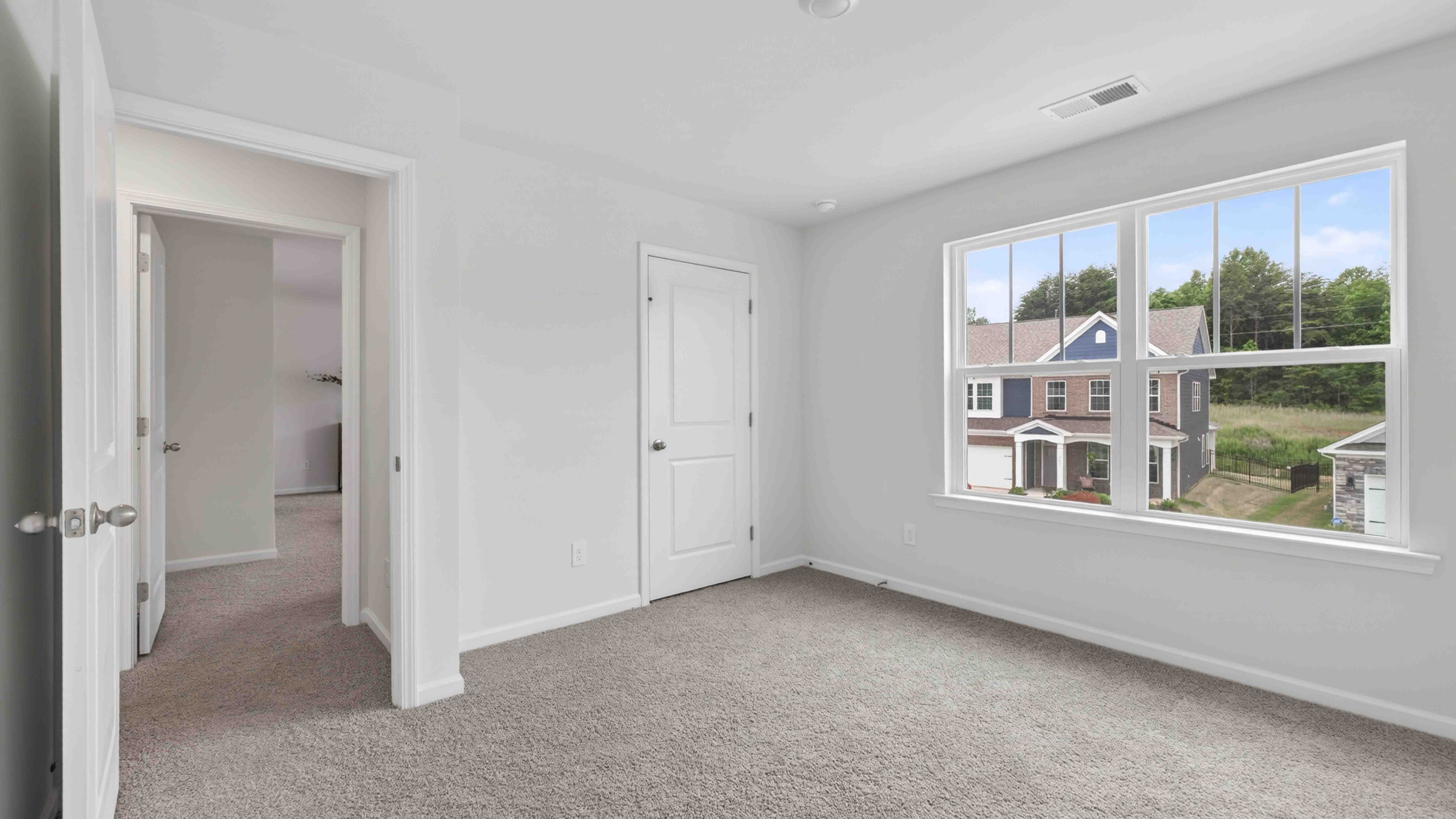 carpeted bedroom with large window