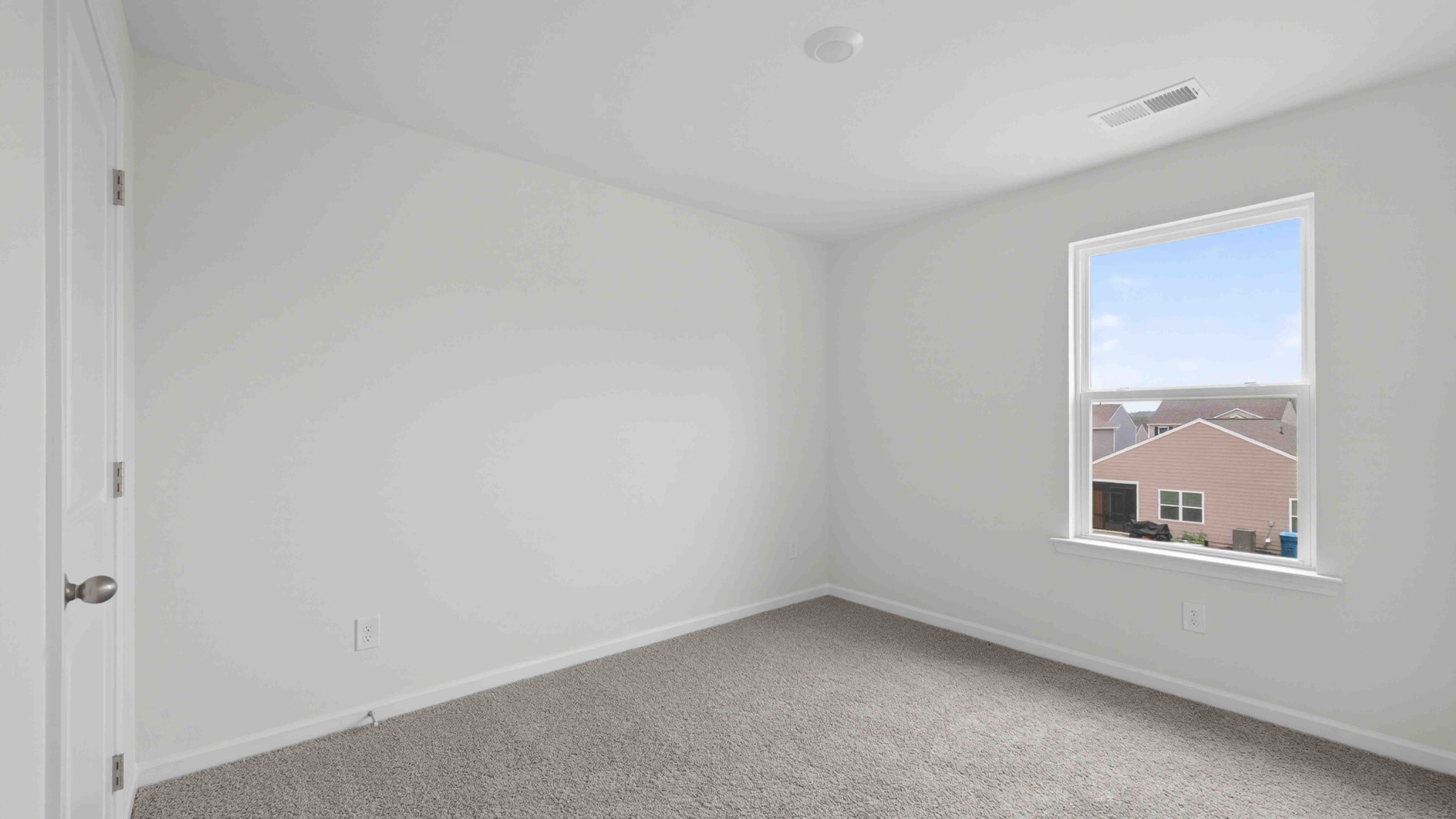 carpeted bedroom with large window