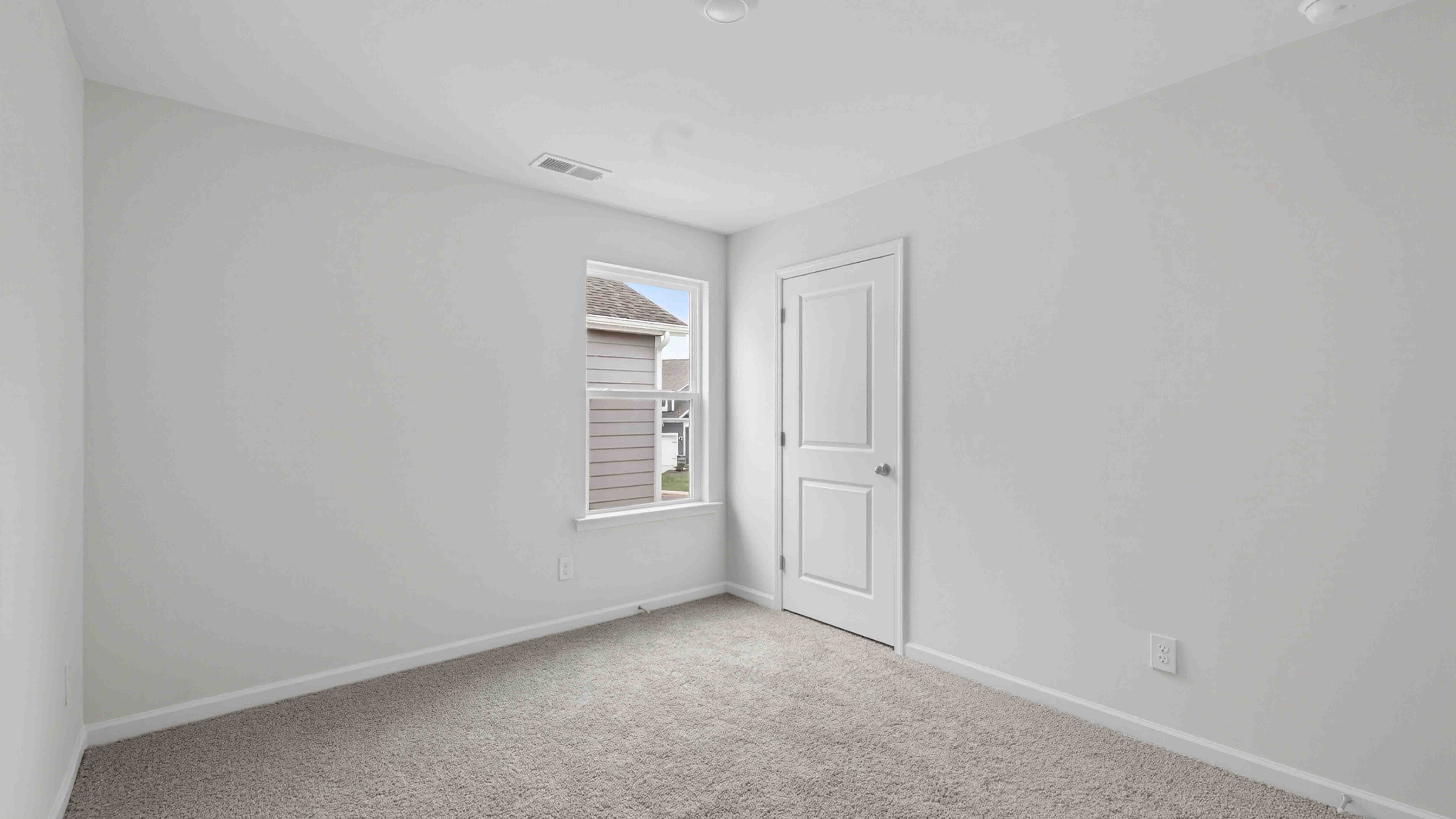 carpeted bedroom with large window