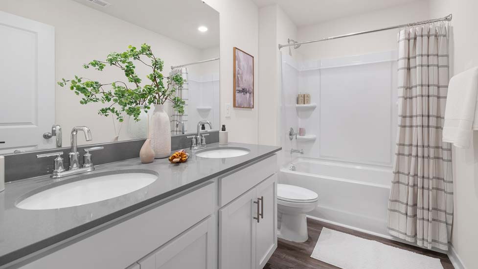 Bathroom with single sink and tub shower combination