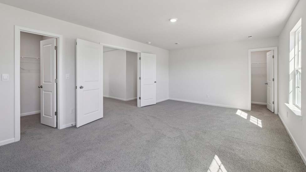 upstairs loft with carpet and large window