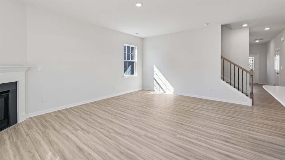 Open concept living roo with fireplace and large windows