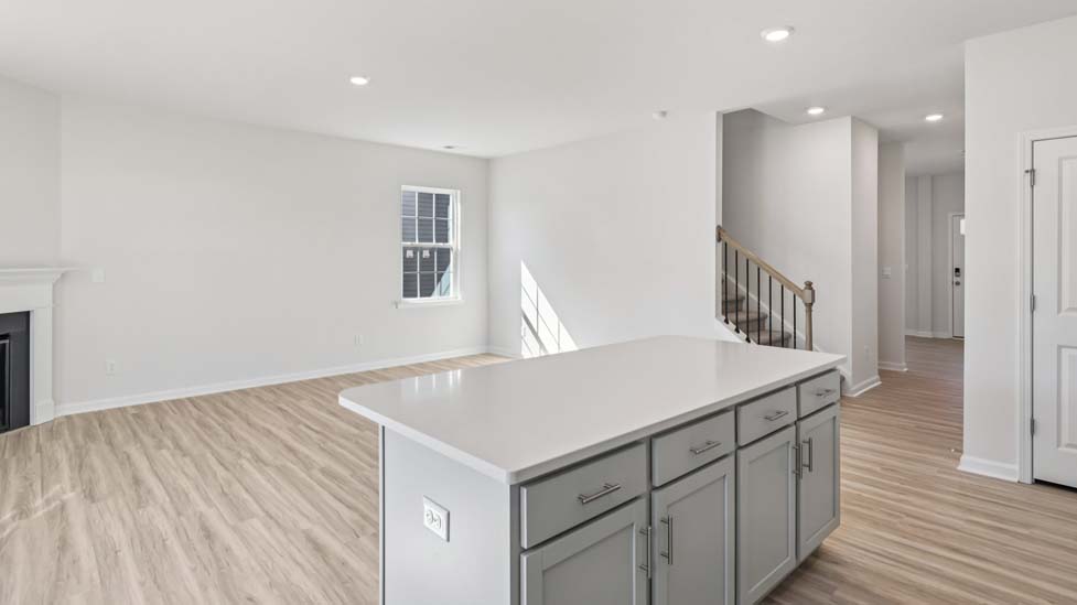 Open concept living roo with fireplace and large windows