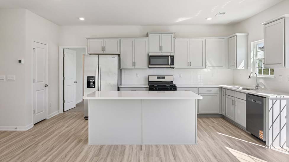 kitchen and island with stainless steel appliances