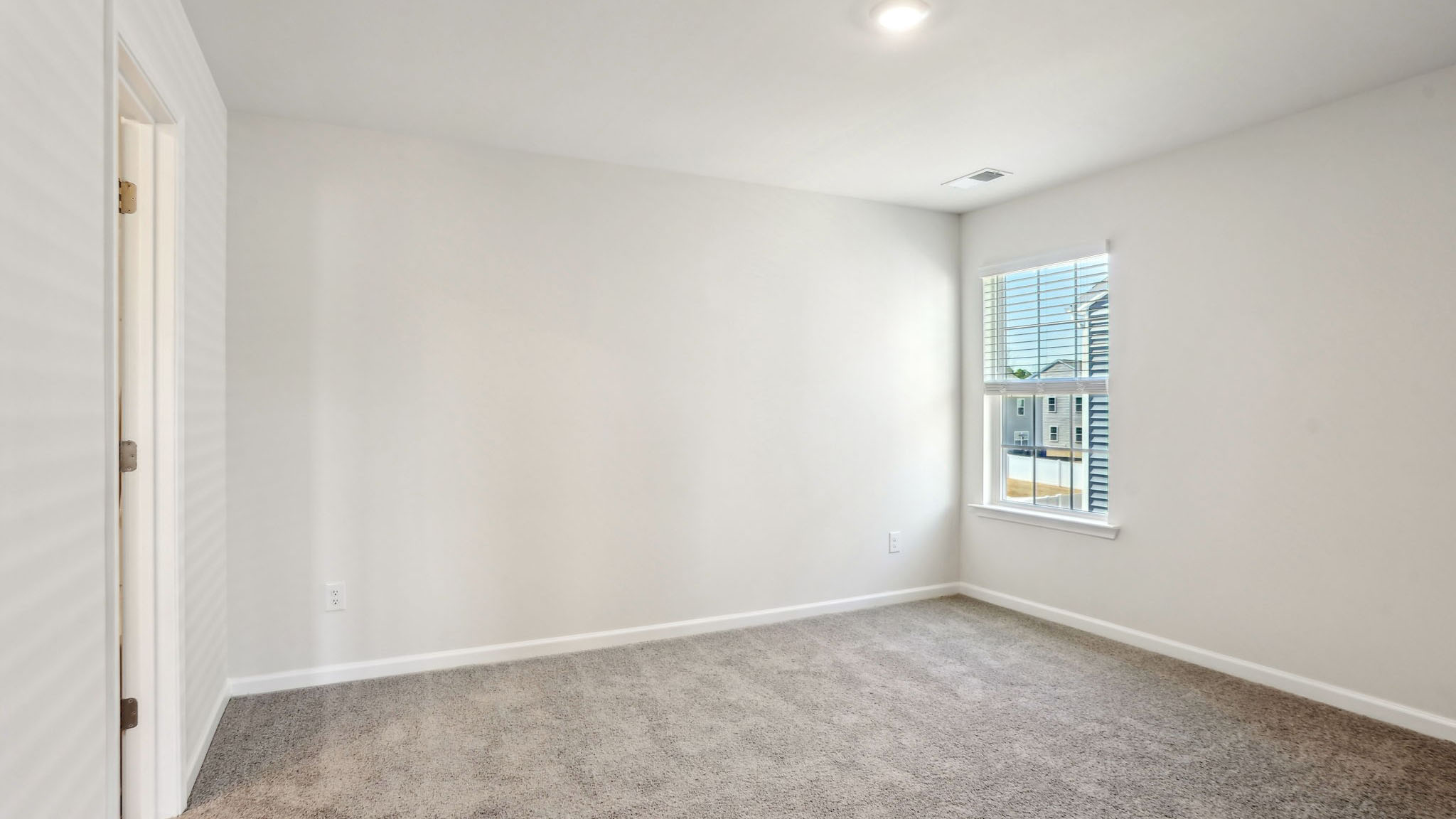 Carpeted bedroom with large window