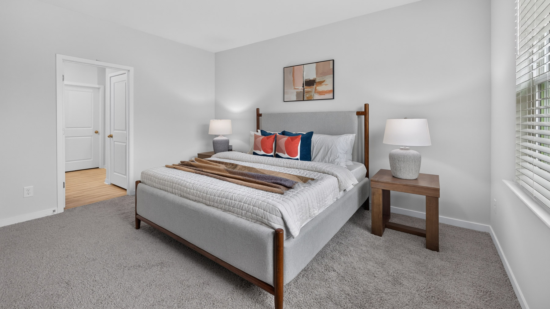 Primary bedroom with carpet and large windowsPrimary bedroom with carpet and large windows