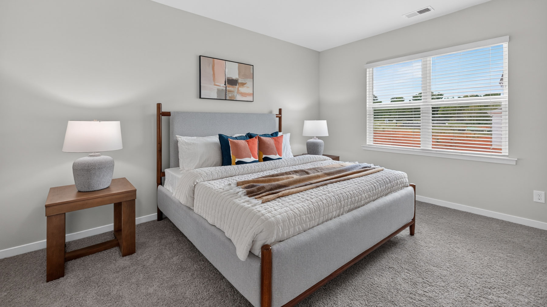 Primary bedroom with carpet and large windowsPrimary bedroom with carpet and large windows