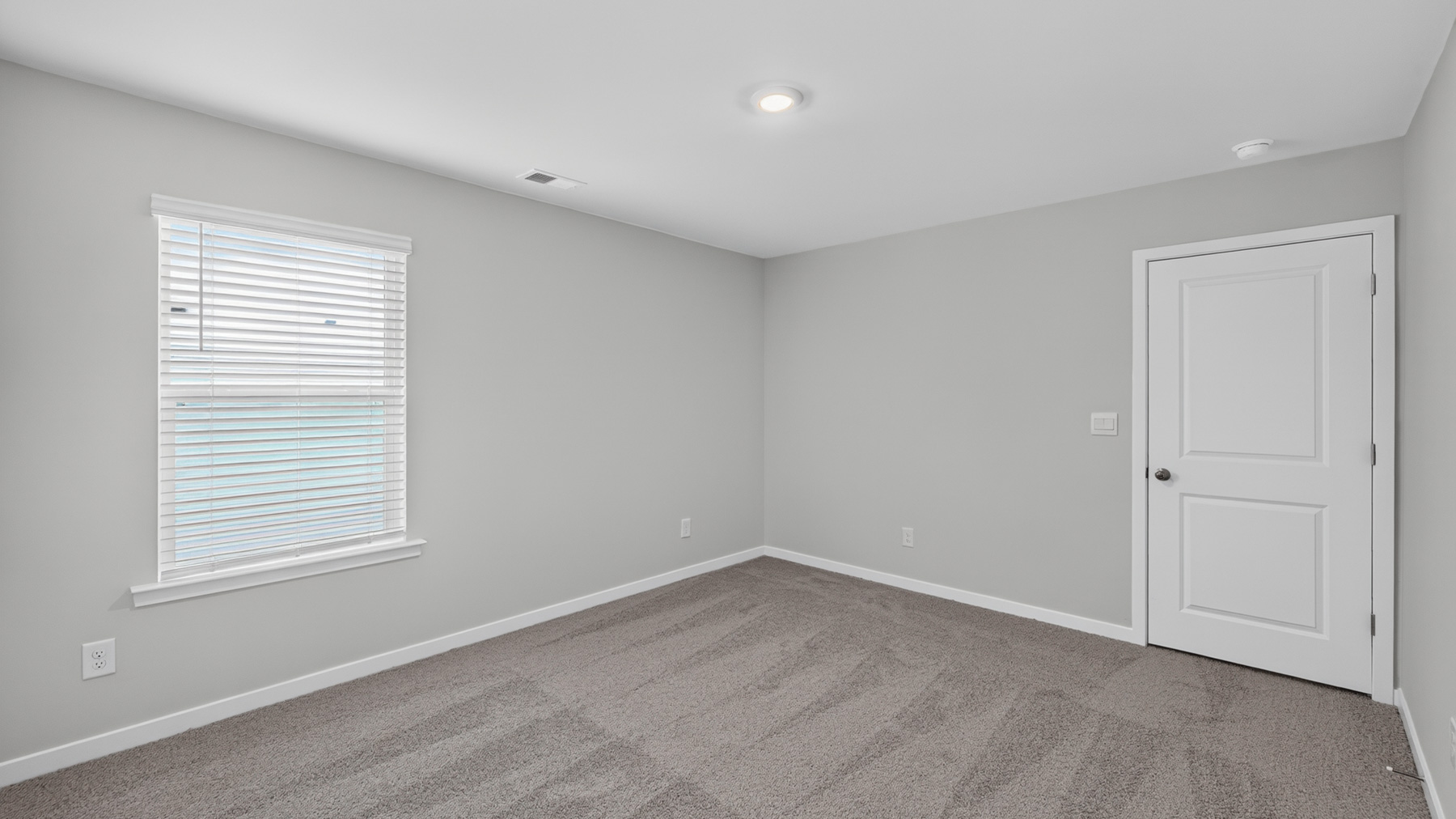 Carpeted bedroom with large window