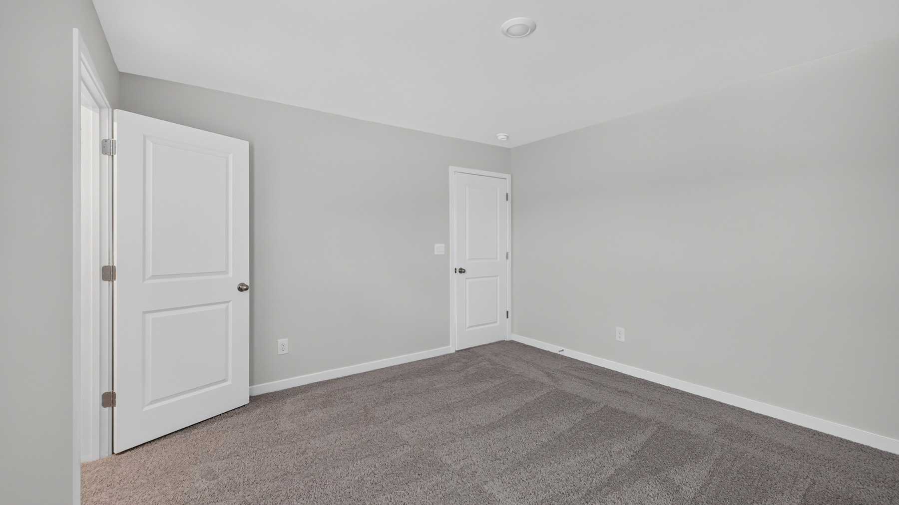 Carpeted bedroom with large window