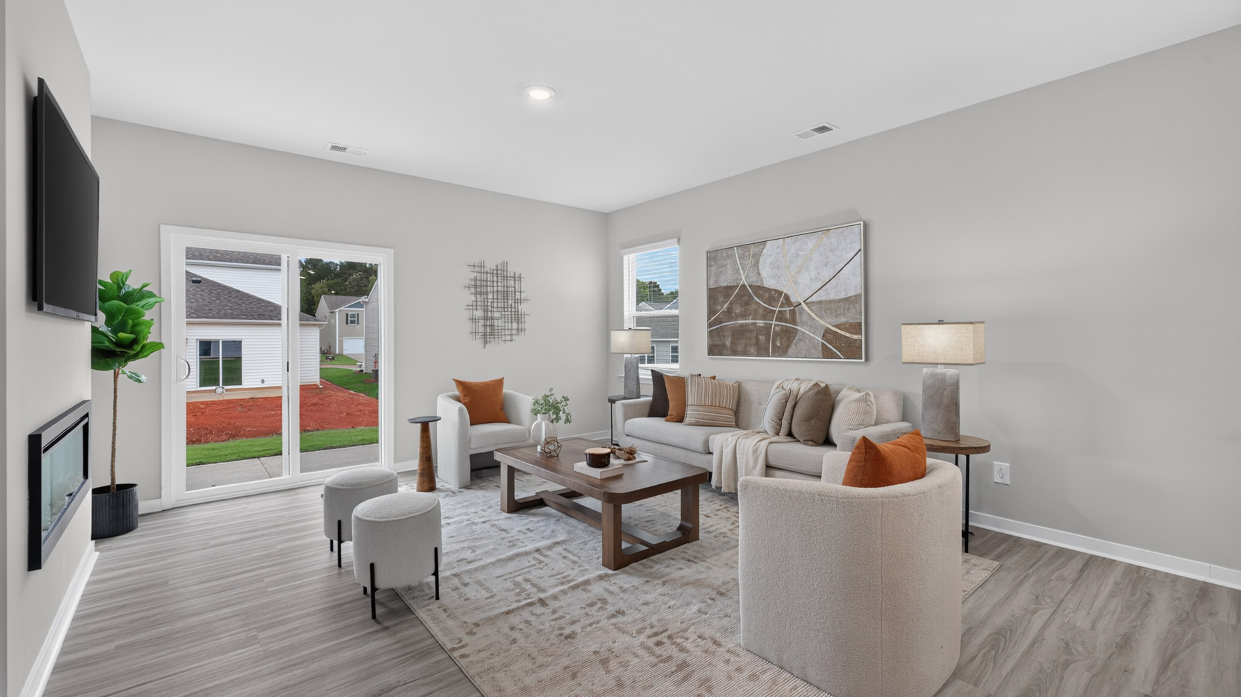 Open living room with fire place, vinyl floors, and large window
