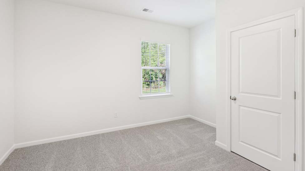 Carpeted bedroom with windows