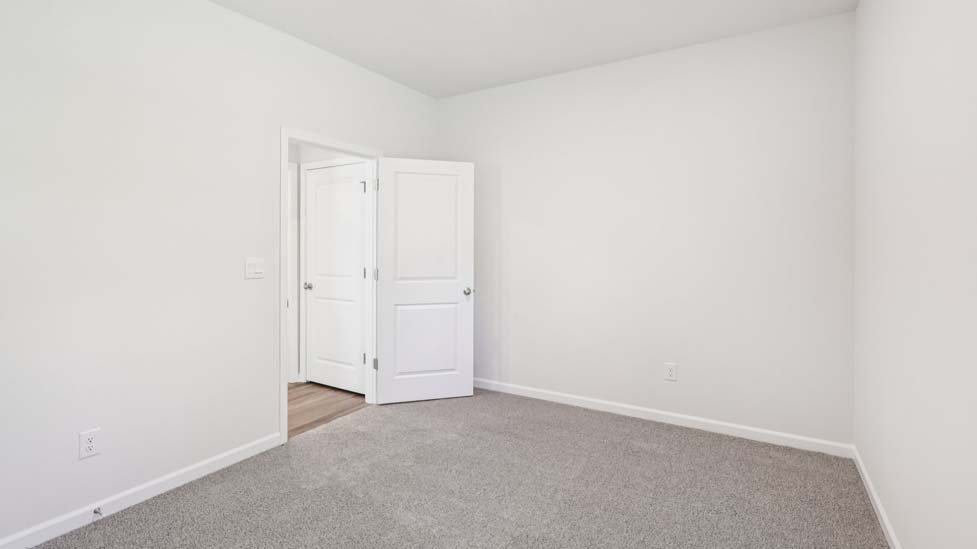 Carpeted bedroom with windows