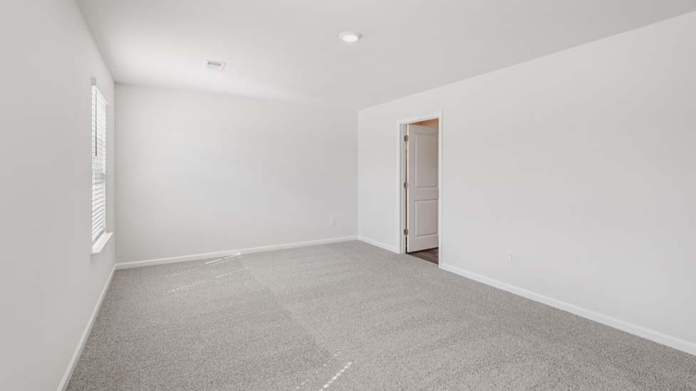 Carpeted bedroom with windows