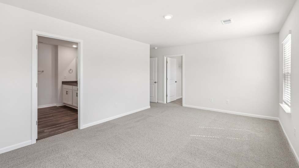 Carpeted bedroom with windows