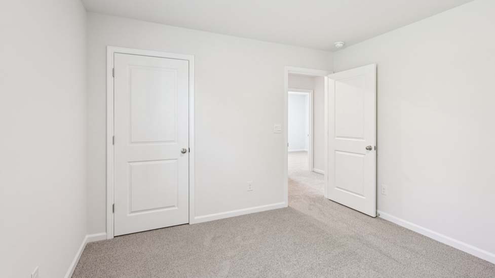 Carpeted bedroom with windows