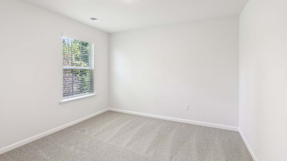 Carpeted bedroom with windows