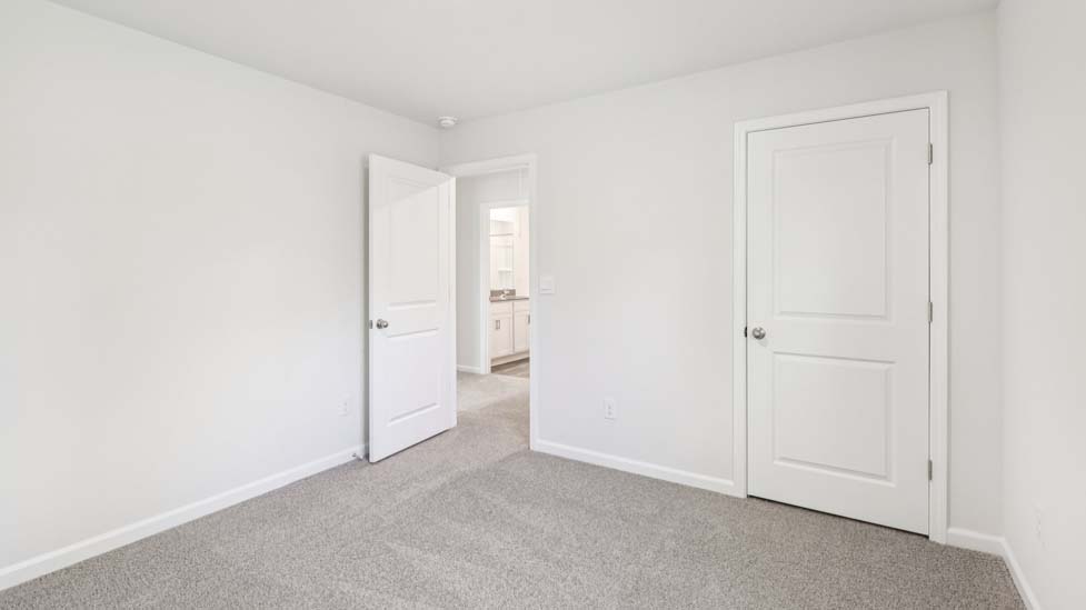 Carpeted bedroom with windows