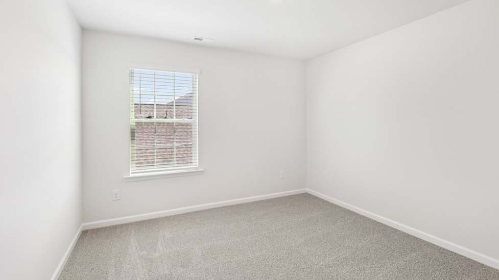 Carpeted bedroom with windows