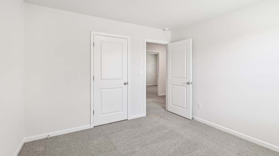 Carpeted bedroom with windows