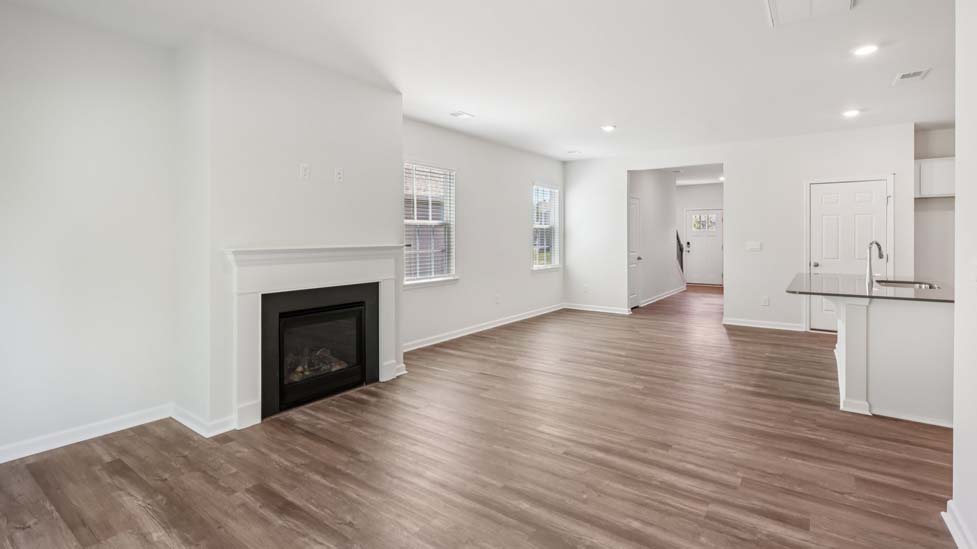 Living room space with windows and fireplace