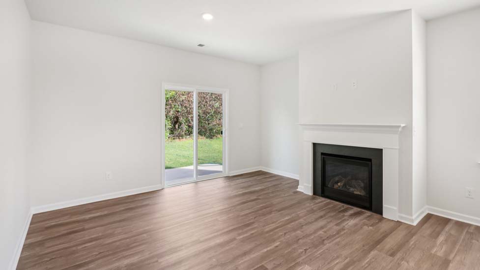 Living room space with windows and fireplace
