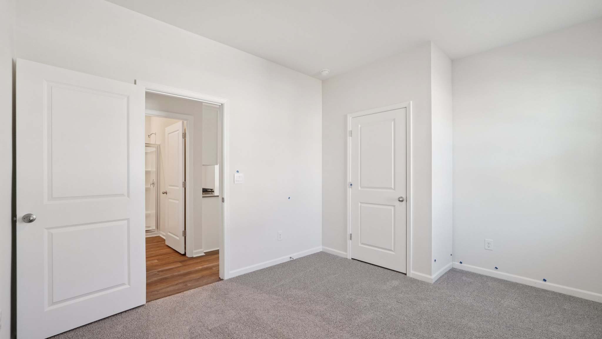 Carpeted bedroom with windows