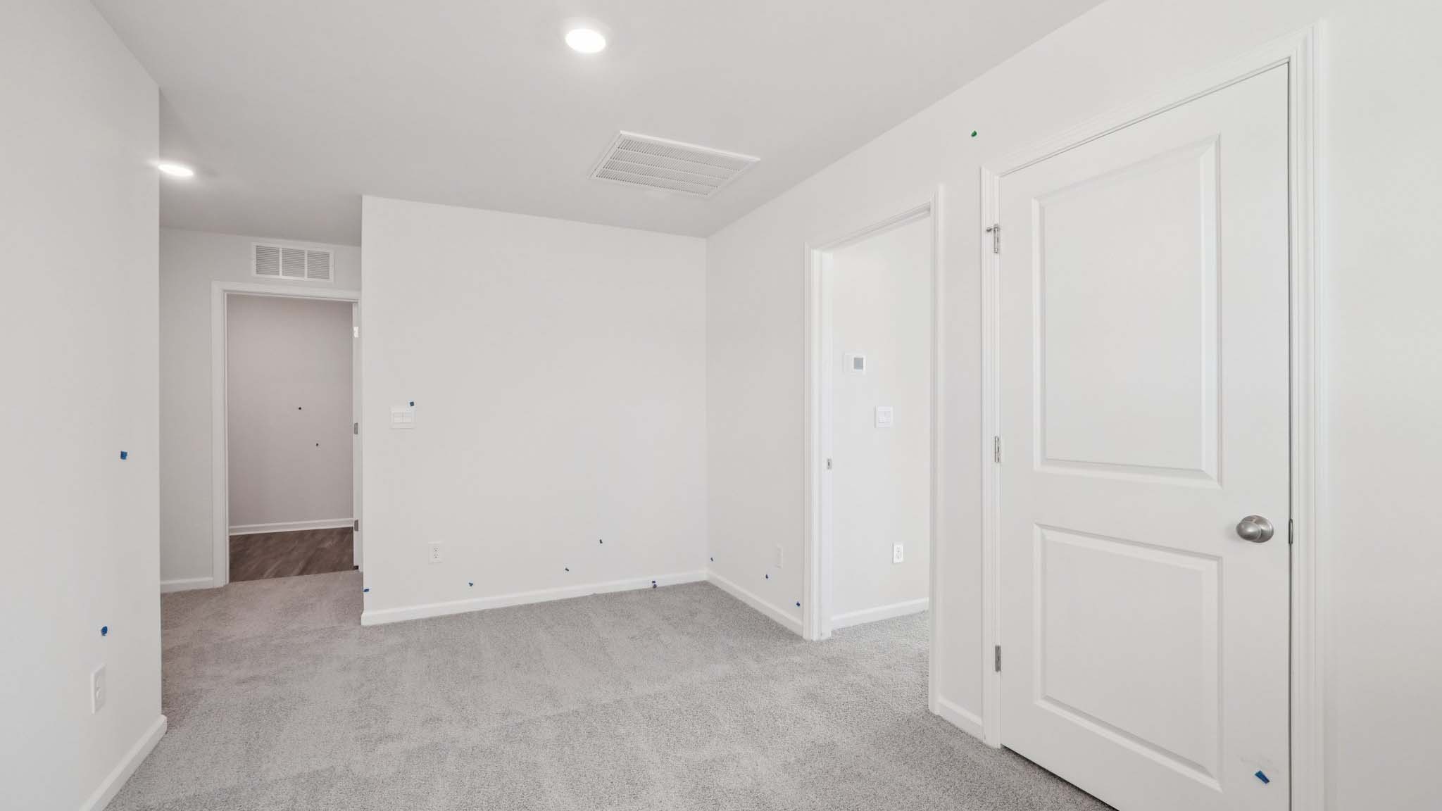 Carpeted bedroom with windows