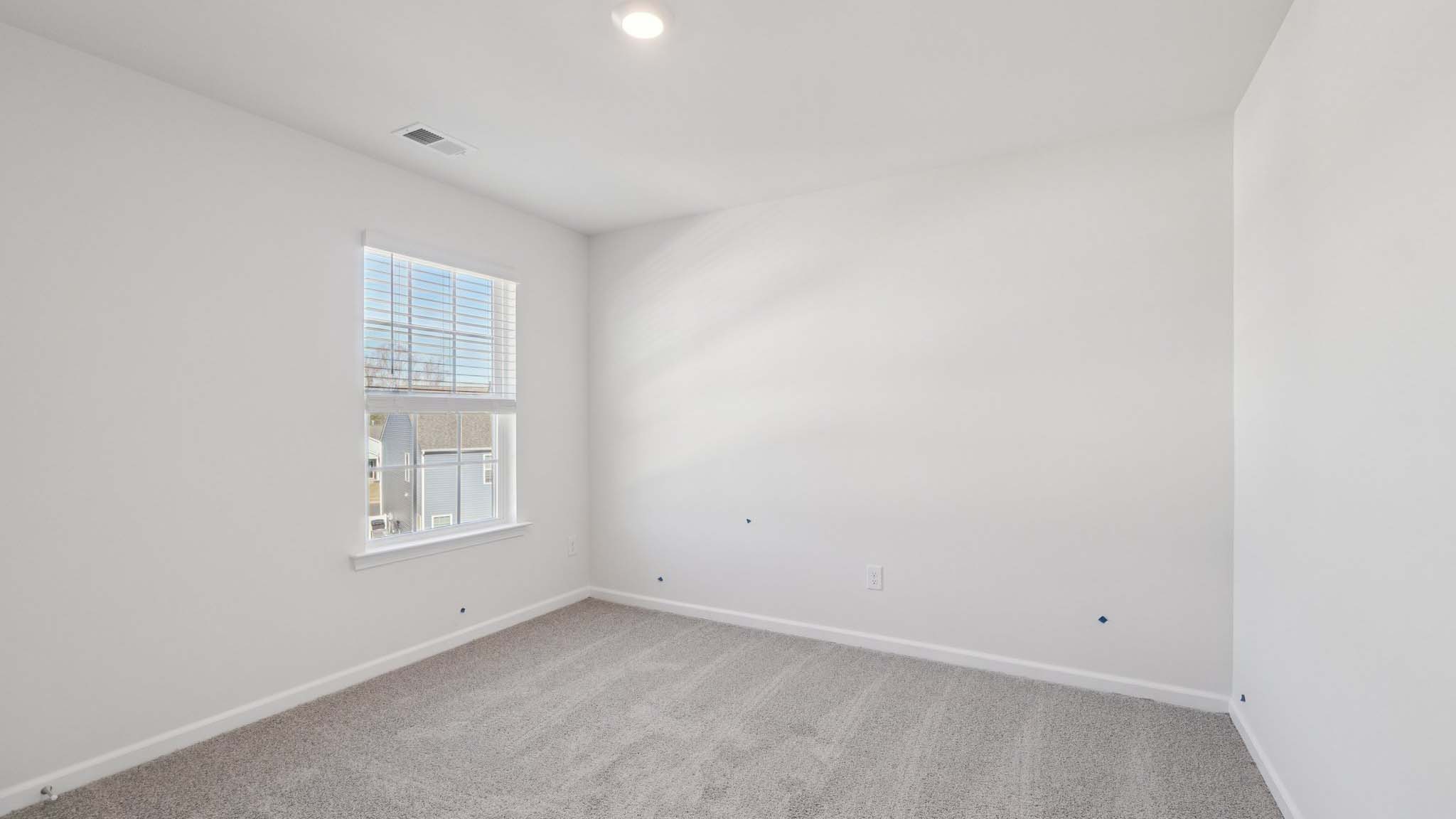 Carpeted bedroom with windows