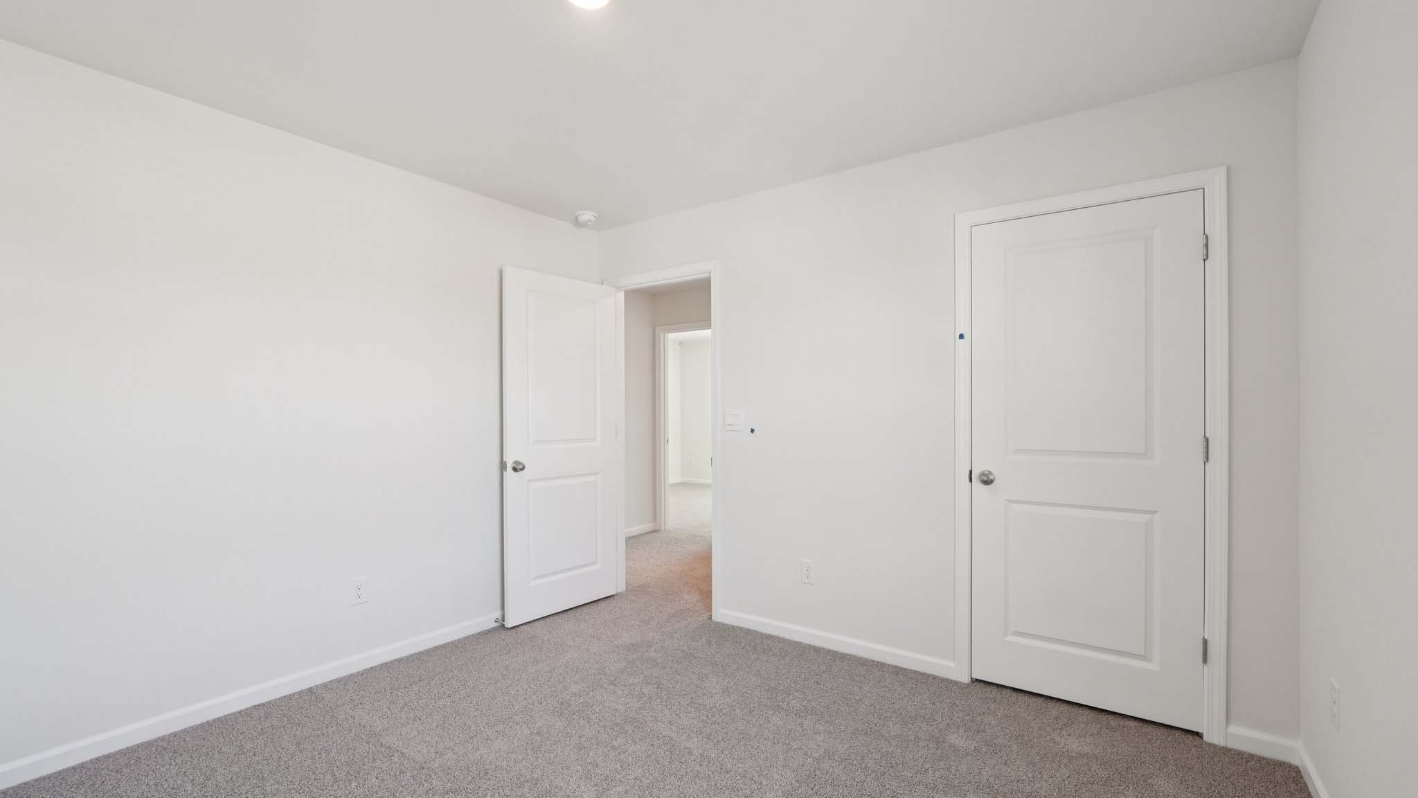 Carpeted bedroom with windows