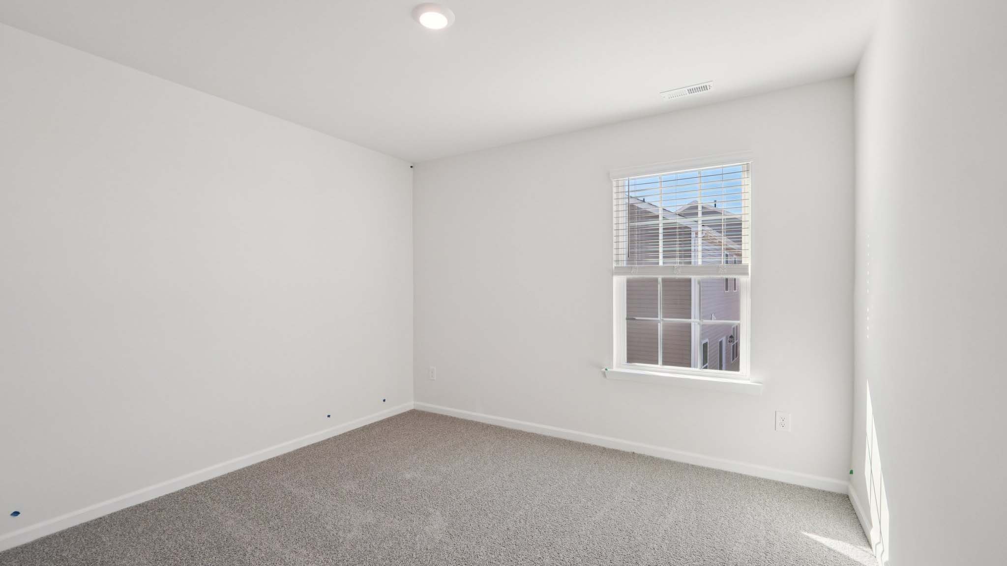 Carpeted bedroom with windows
