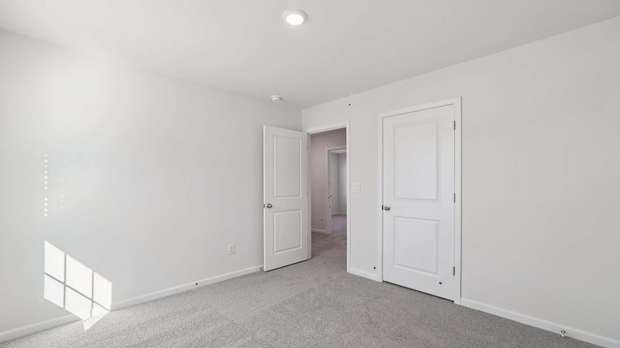 Carpeted bedroom with windows