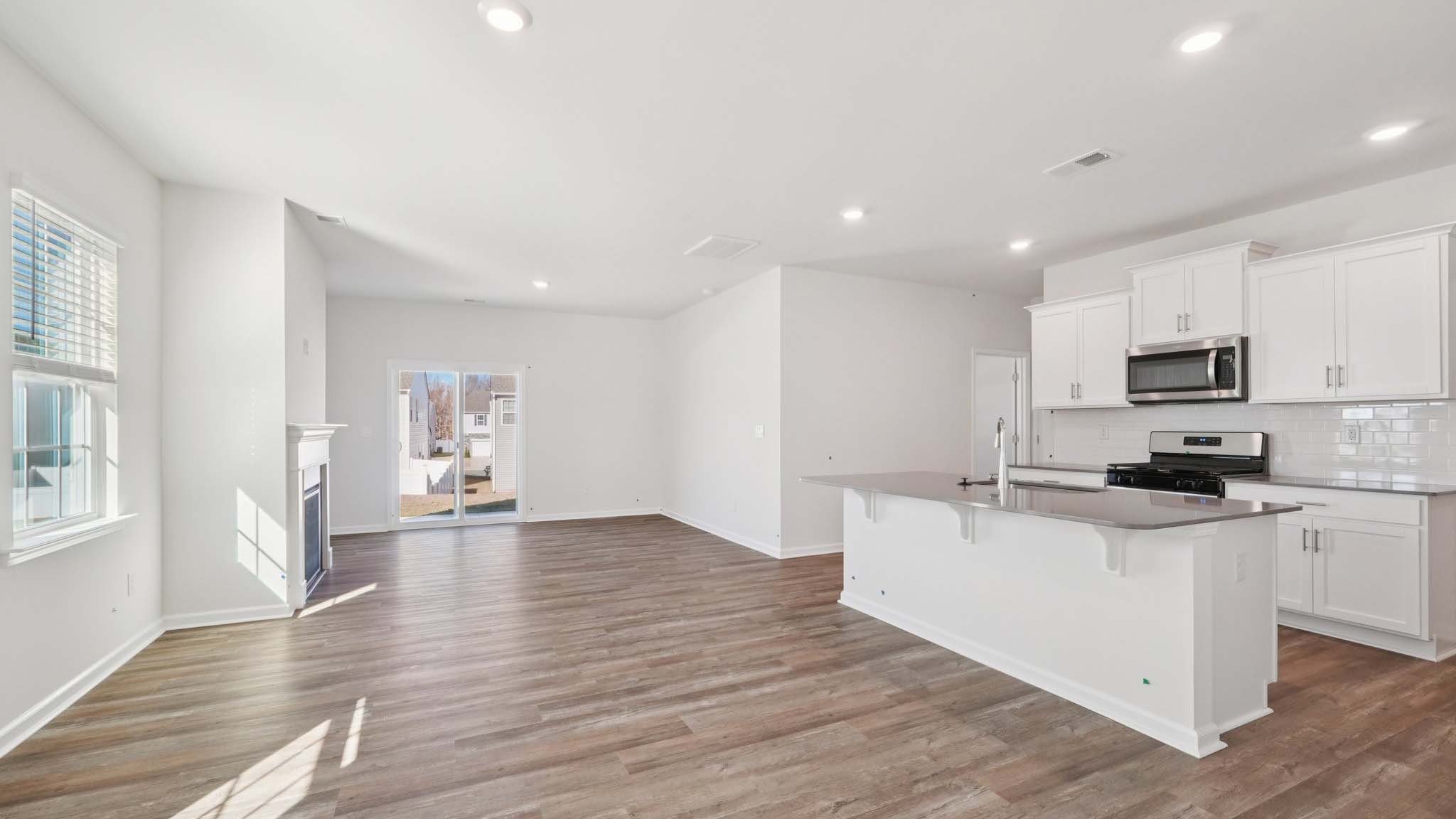 Living room space with windows and fireplace