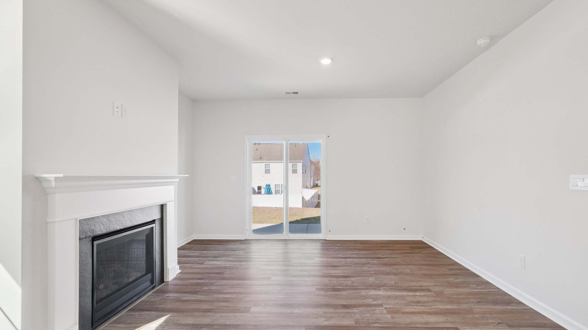 Living room space with windows and fireplace