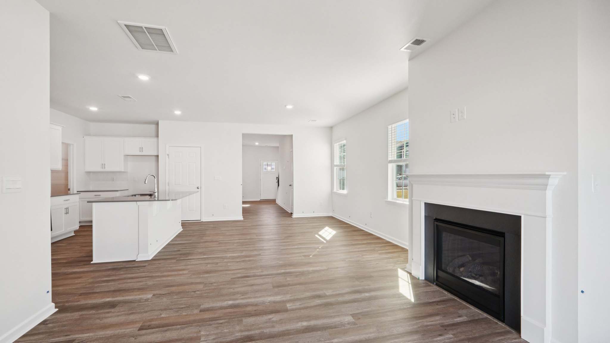 Living room space with windows and fireplace