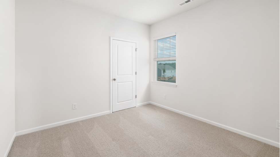 Carpeted bedroom with window