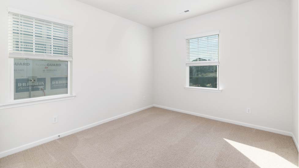 Carpeted bedroom with window