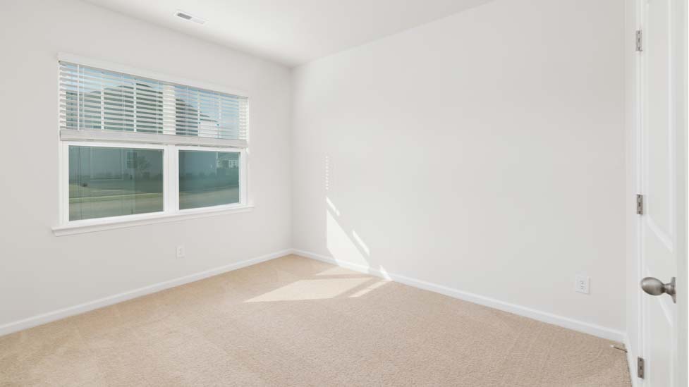 Carpeted bedroom with window