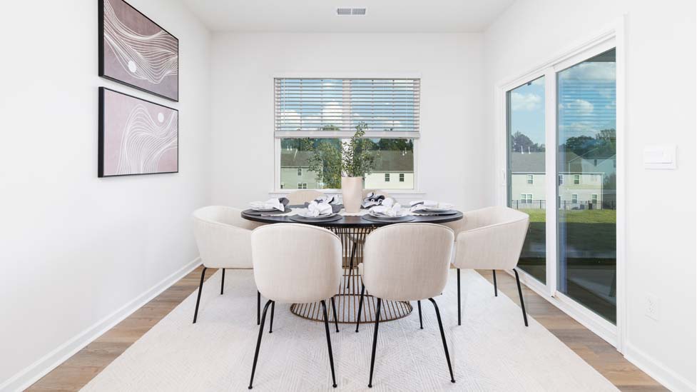 Dining room with large window, and sliding glass back door