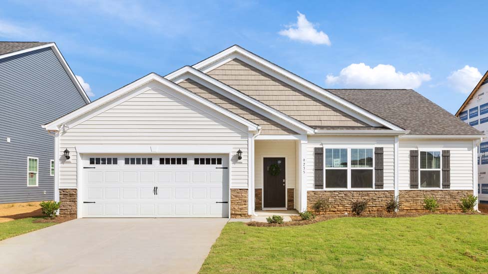 Booth front exterior with beige siding, stone and garage