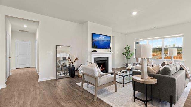 Open family room with large windows, and fireplace