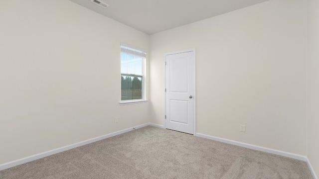 Carpeted bedroom with small window