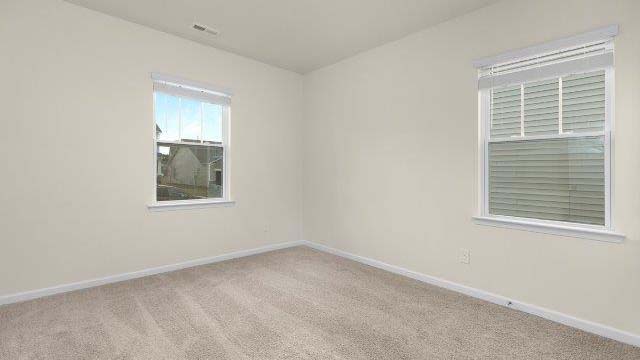 Carpeted bedroom with small window
